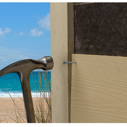 Fiber Cement Siding Nail, Line art, Ring Shank, Checkered Head, Stainless Steel; Fiber Cement Siding Nail being hammered into siding on a beachfront property